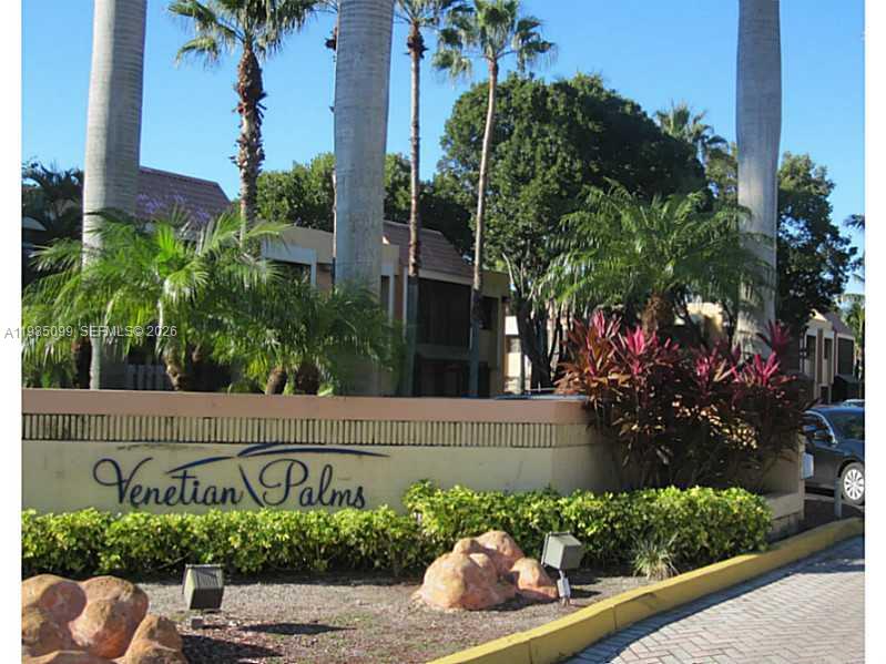 The exterior sign for Venetian Palms features palm trees, landscaping, and a paved driveway — 7913 SW 104th St # G, Miami FL 33156, MIAMI, FL