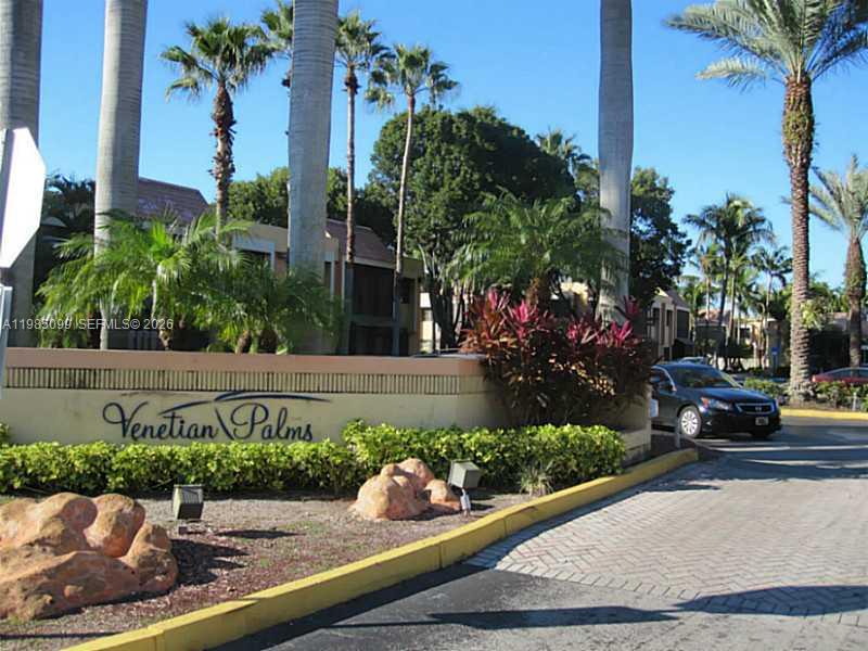 The entrance sign for Venetian Palms features palm trees, landscaping, and a paved driveway — 7913 SW 104th St # G, Miami FL 33156, MIAMI, FL