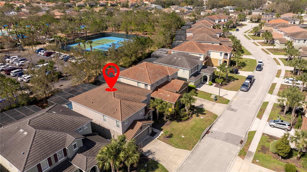 An aerial view shows a two-story suburban house with a tiled roof and pool enclosure — 5251 WILDWOOD WAY, DAVENPORT, FL