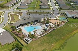 An aerial view shows a community clubhouse with a swimming pool, playground, and parking lot — 4163 SW 53RD LANE ROAD, OCALA, FL