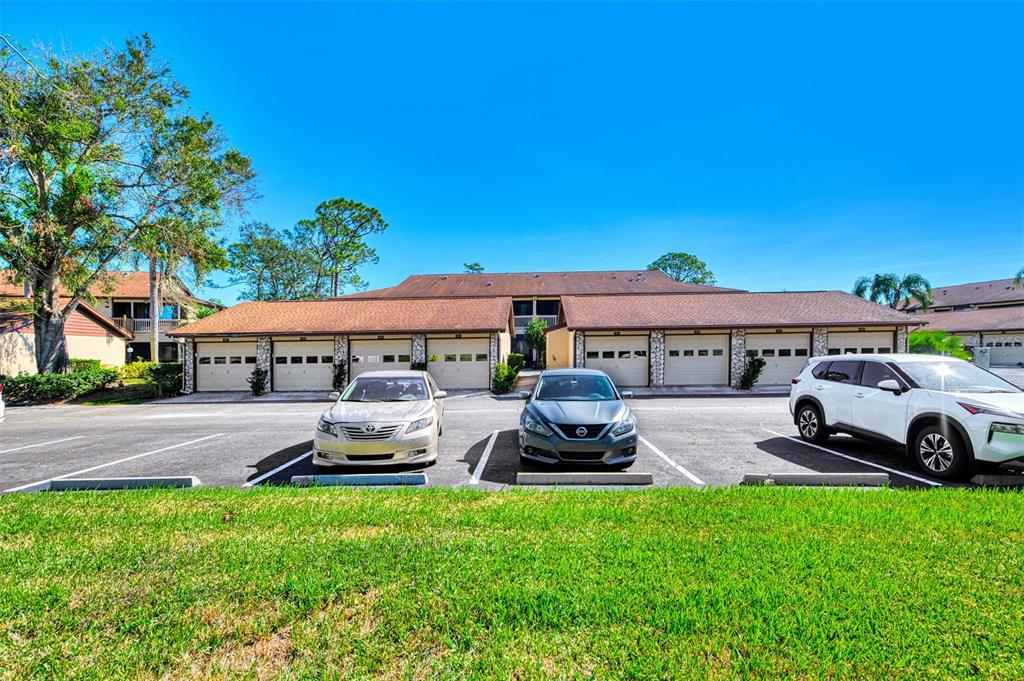 A two-story residential building with attached garages and parked cars in front — 5761 AVISTA DRIVE UNIT 5761, SARASOTA, FL
