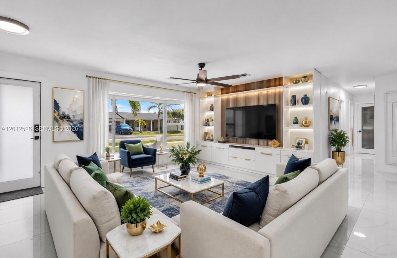 A modern living room features a white sectional sofa, a built-in media wall, and large windows — 14234 SW 75th Ter, Miami FL 33183, MIAMI, FL
