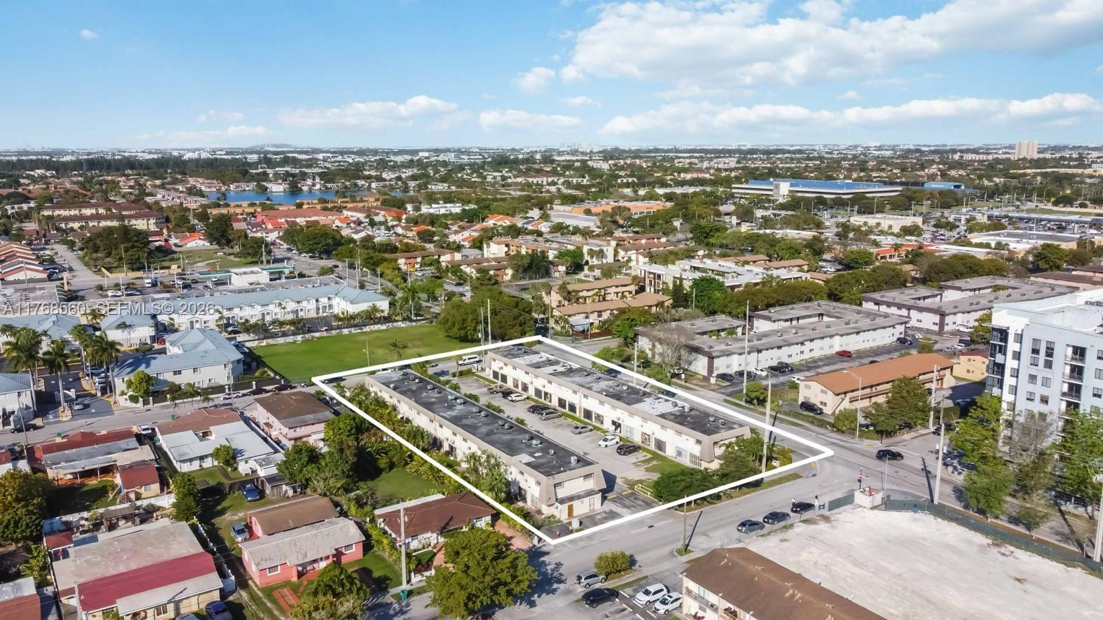 An aerial view shows a rectangular commercial building complex surrounded by parking and residential neighborhoods — 10904 SW 2nd, Sweetwater FL 33174, SWEETWATER, FL