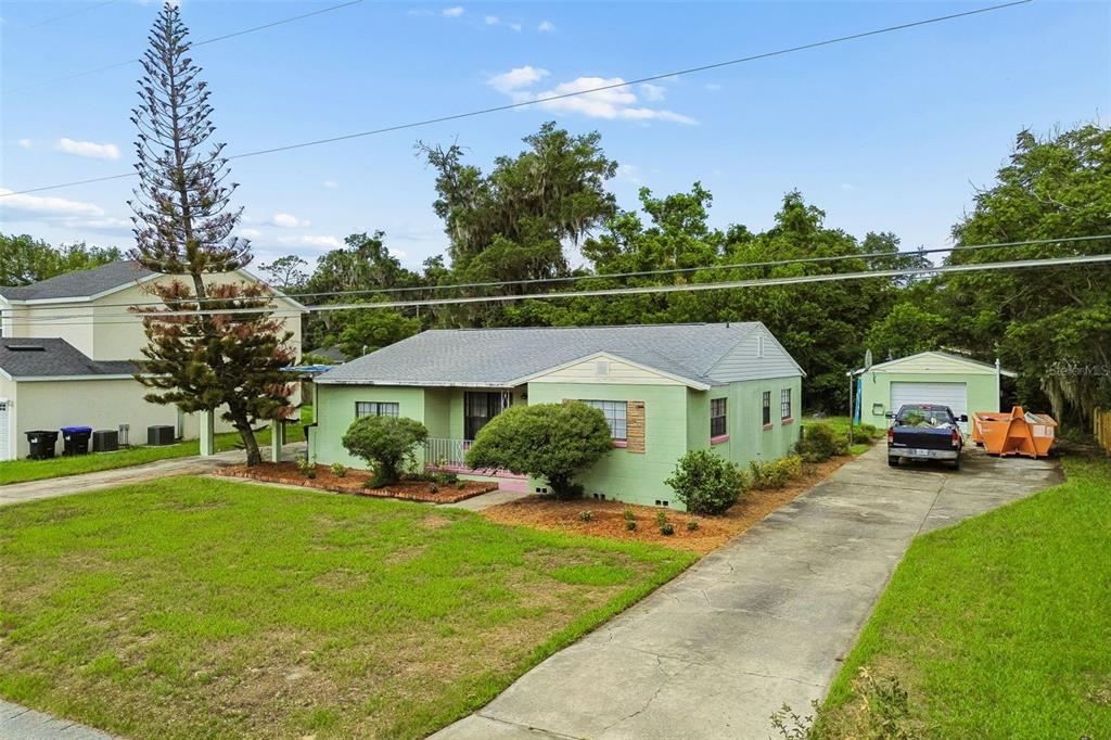 A light green single-story house with a concrete driveway and a detached garage — 3742 MARTIN STREET, ORLANDO, FL