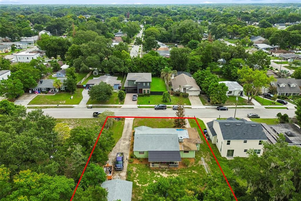 An aerial view shows a residential property with a green house and a detached garage — 3742 MARTIN STREET, ORLANDO, FL