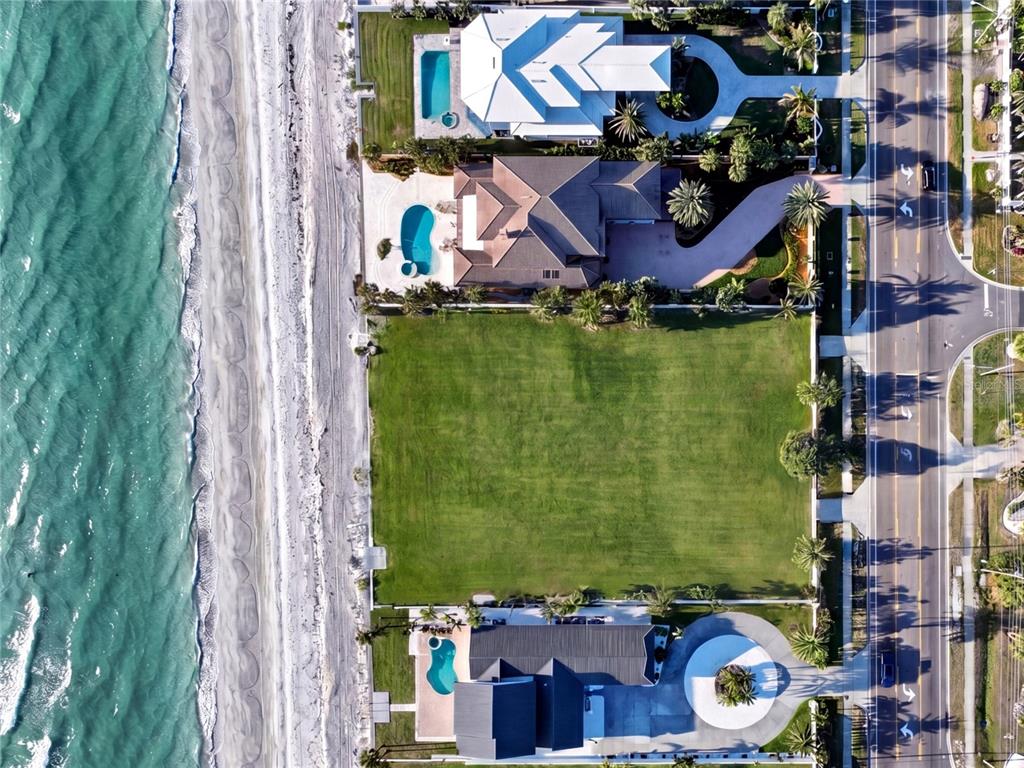 An aerial view of a coastal property featuring a white sand beach and turquoise water — 1420 and 1440 GULF BOULEVARD, BELLEAIR SHORE, FL
