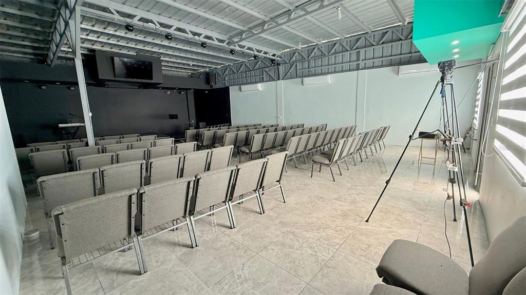A modern, open-plan event space features rows of gray chairs, tile flooring, and exposed rafters — 156 SECTOR, KM 13.5 PR-156, BARRANQUITAS, PR