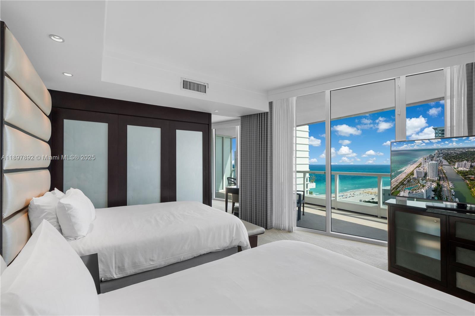 A hotel room with two beds, a dark wood wardrobe, and a balcony overlooking the ocean — 4391 Collins Ave # 1619, Miami Beach FL 33140, MIAMI BEACH, FL