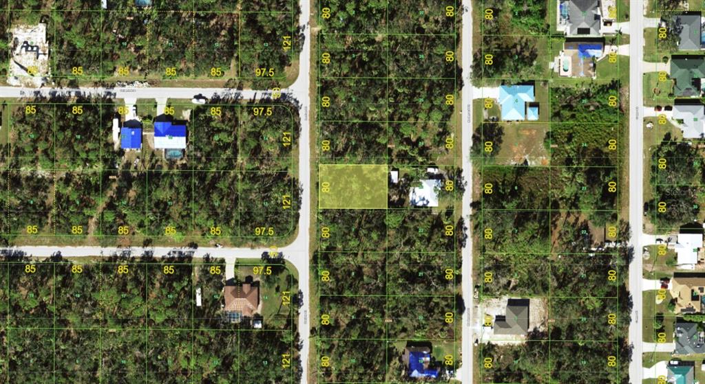 This is an aerial map showing a highlighted rectangular lot surrounded by wooded residential parcels — 2168 DORION STREET, PORT CHARLOTTE, FL