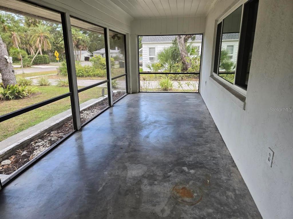 A screened-in porch with a concrete floor and views of a residential neighborhood — 859 PATTERSON DRIVE, SARASOTA, FL