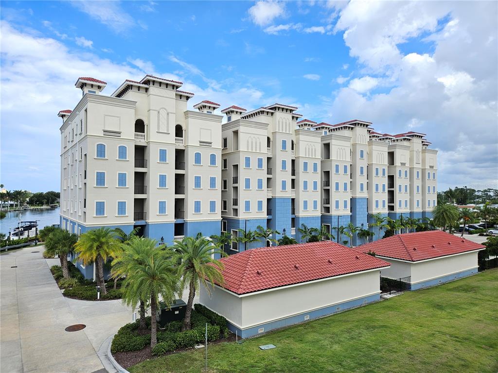An exterior view of a multi-story apartment building with blue and cream walls — 503 TAMIAMI TRAIL N UNIT 301, VENICE, FL