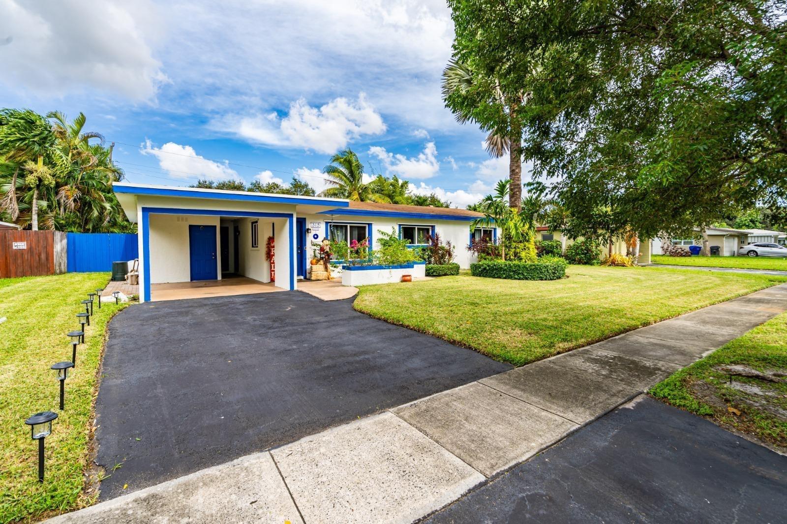 A single-story house with a blue-trimmed exterior, a carport, and a paved driveway — 315 S 57th Avenue, Hollywood FL 33023, HOLLYWOOD, FL