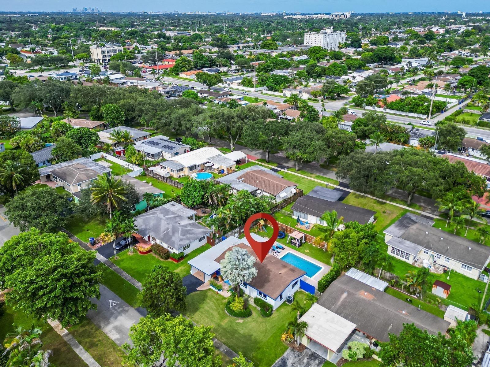 An aerial view of a single-story suburban house with a swimming pool and palm tree — 315 S 57th Avenue, Hollywood FL 33023, HOLLYWOOD, FL
