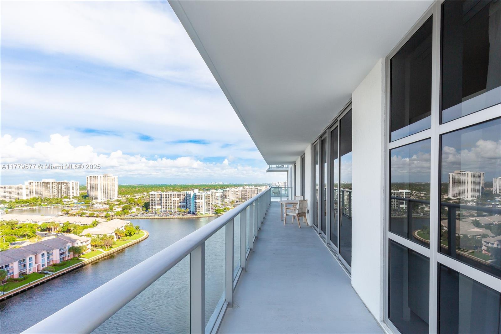 A high-rise balcony features a glass railing, concrete flooring, and a view of a waterway — 4010 S Ocean Dr # R2204, Hollywood FL 33019, HOLLYWOOD, FL