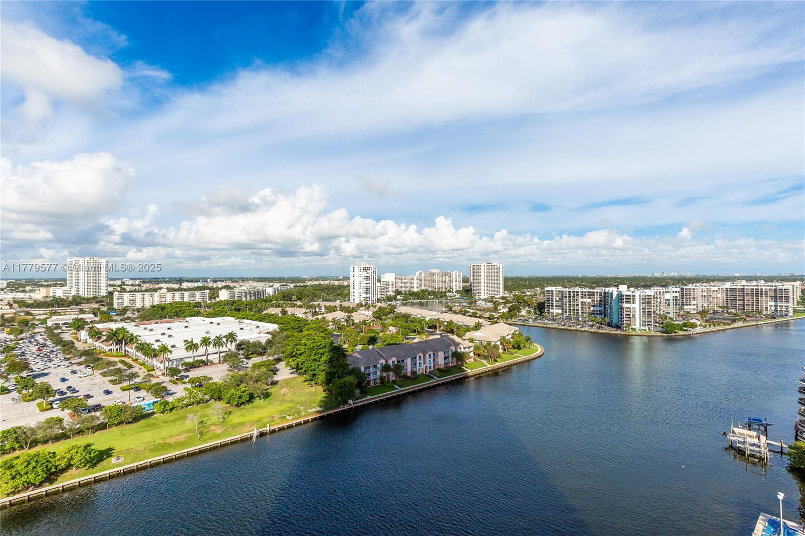 An aerial view shows a waterway winding past residential buildings, parking lots, and green spaces — 4010 S Ocean Dr # R2204, Hollywood FL 33019, HOLLYWOOD, FL