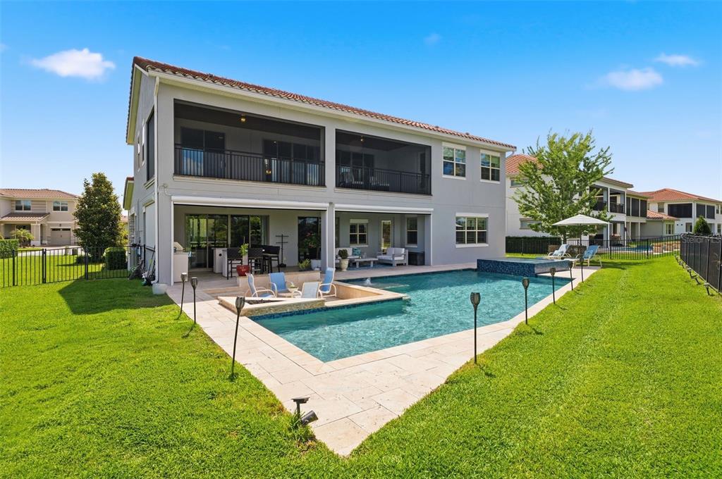 A two-story house with a screened balcony, a swimming pool, and a patio area — 9110 MORGANA COURT, WINTER GARDEN, FL