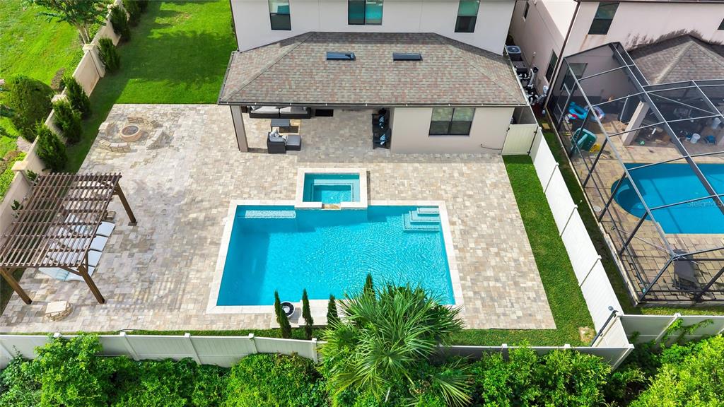 A two-story house exterior features a covered patio, a swimming pool, and a spa — 10037 LEYBURN COURT, ORLANDO, FL