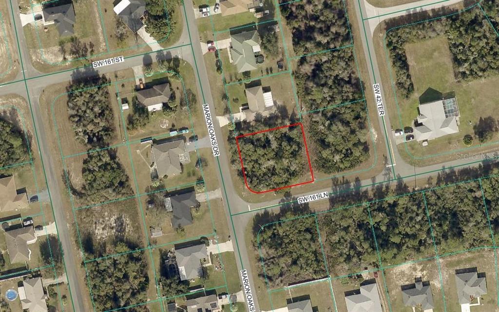 This is an aerial map showing a vacant, wooded residential lot outlined in red — MARION OAKS DRIVE, OCALA, FL