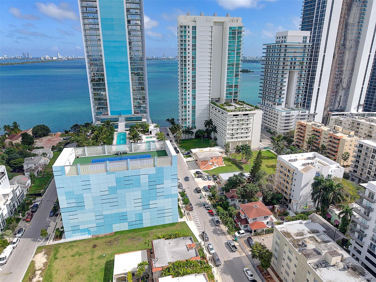 An aerial view shows a city street lined with high-rise buildings and residential houses — 471 NE 25th Street # 503, Miami FL 33137, MIAMI, FL