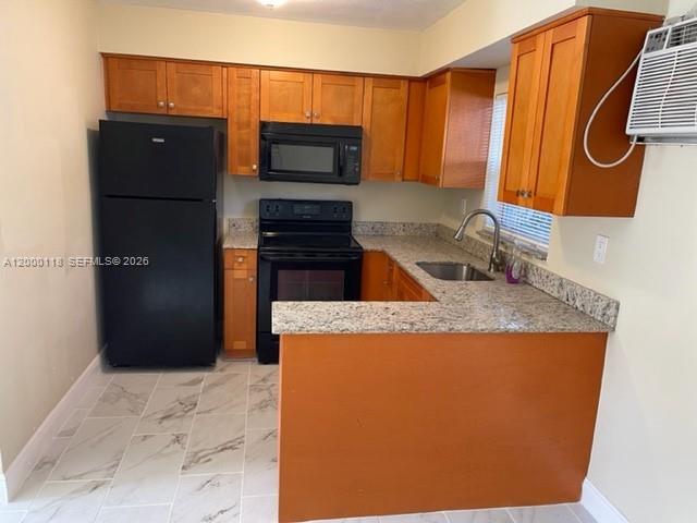 A kitchen features wooden cabinets, granite countertops, a black refrigerator, and a black stove — 7601 Venetian St # 4, Miramar FL 33023, MIRAMAR, FL