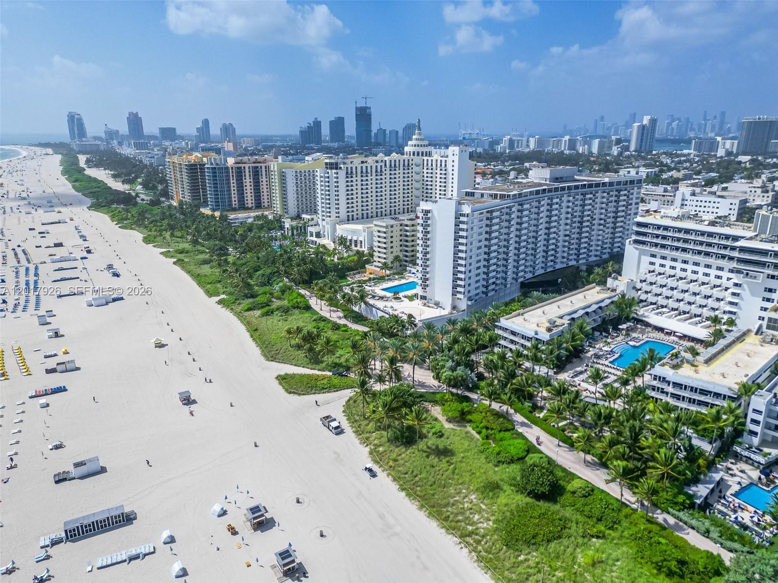 An aerial view shows a sandy beach next to large hotels and palm trees — 100 Lincoln Rd # 539, Miami Beach FL 33139, MIAMI BEACH, FL
