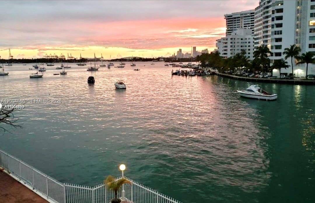 A view of a bay at sunset with many boats and high-rise buildings nearby — 1441 Lincoln Rd # 212, Miami Beach FL 33139, MIAMI BEACH, FL