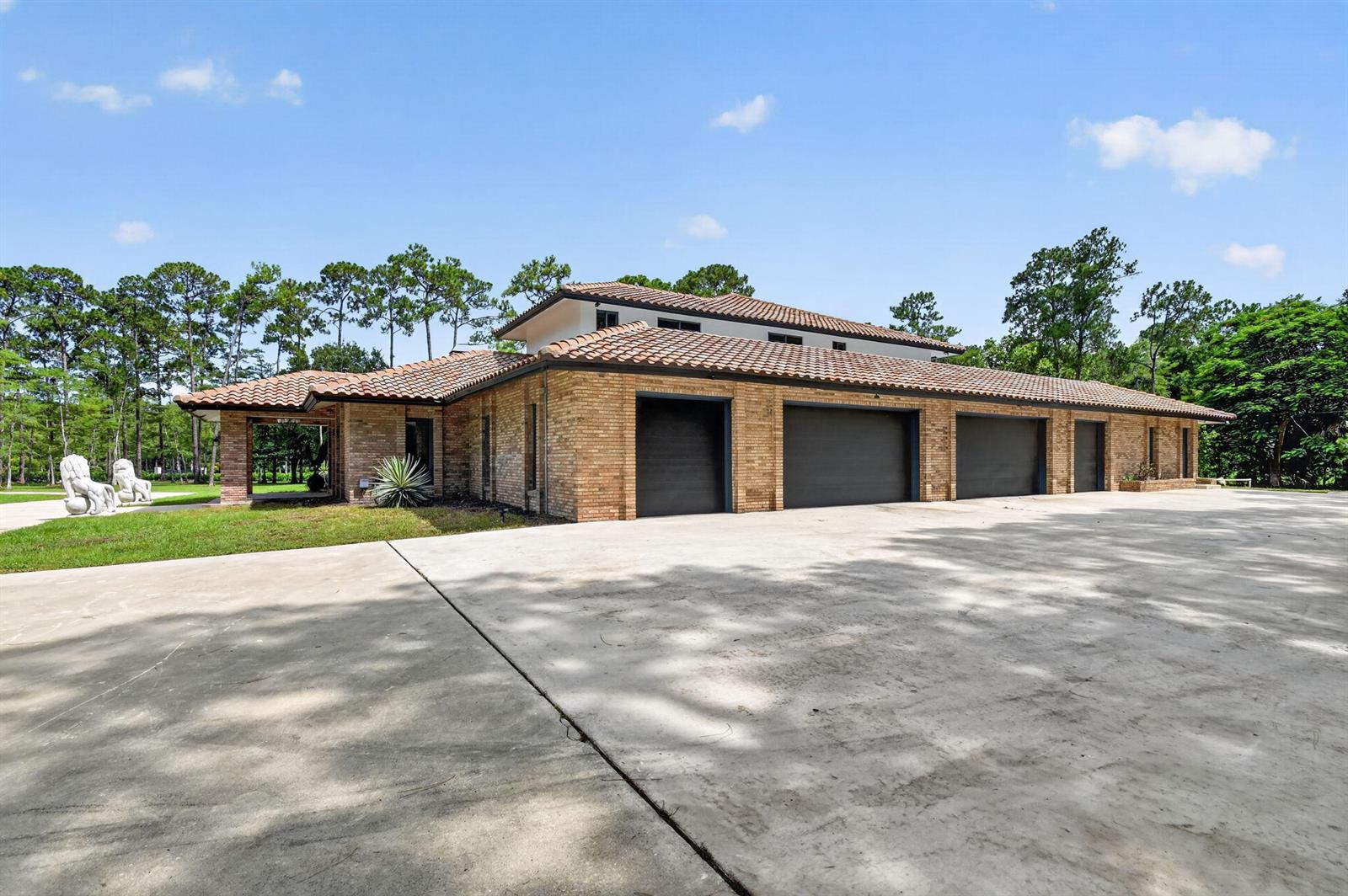 A single-story brick house with a tile roof and a four-car garage — 14780 Draft Horse Lane, Wellington FL 33414, WELLINGTON, FL