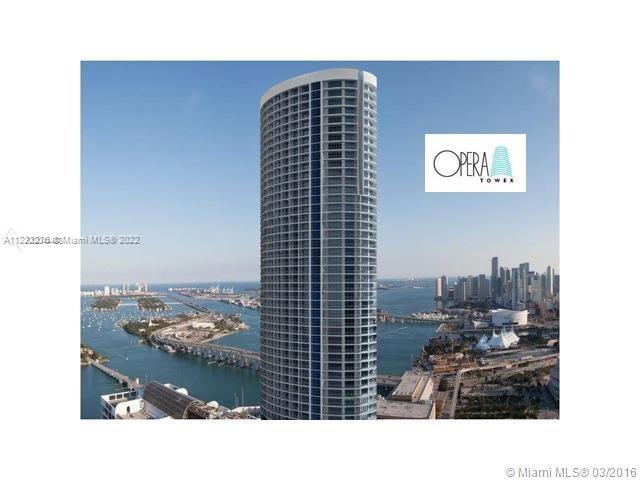 An aerial view of the tall, cylindrical Opera Tower building overlooking a bay and city skyline — 1750 N Bayshore Dr # 2806, Miami FL 33132, MIAMI, FL