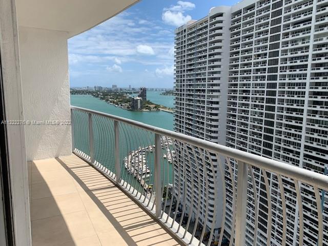 A high-rise balcony overlooks a bay with a marina and a neighboring apartment building — 1750 N Bayshore Dr # 2806, Miami FL 33132, MIAMI, FL