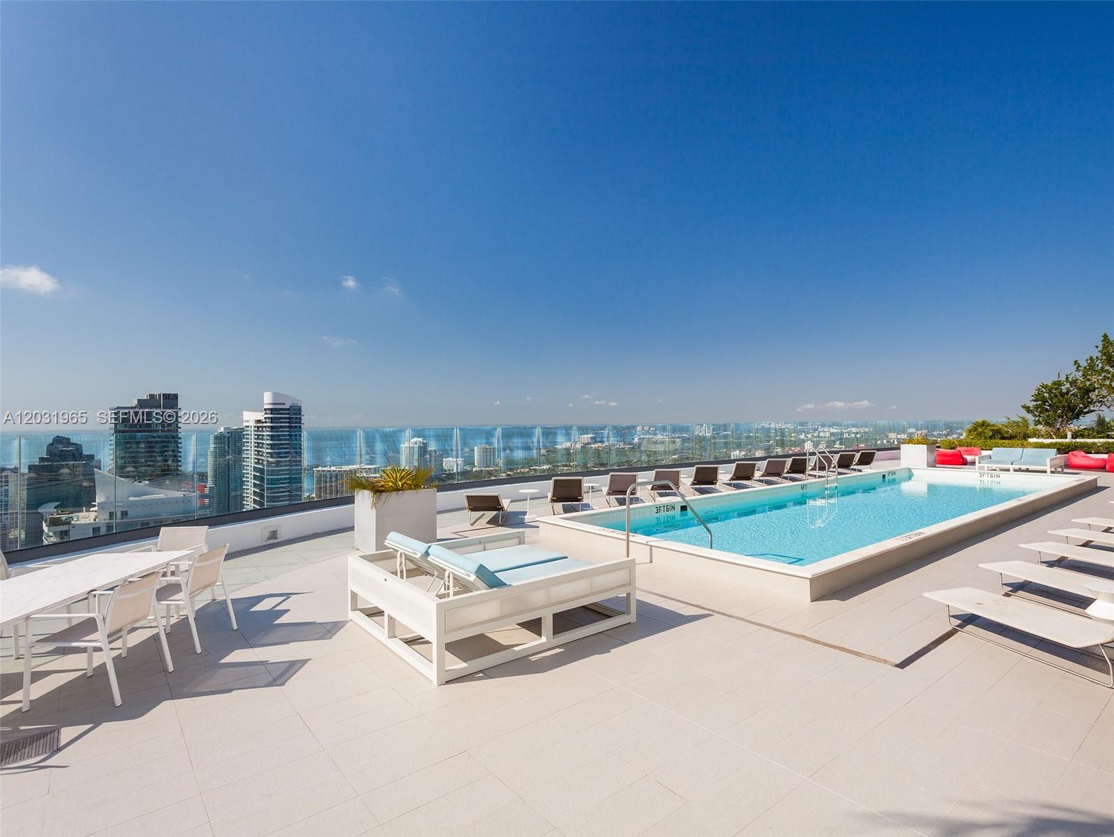 A rooftop terrace features a swimming pool, lounge chairs, and a dining area with city views — 45 SW 9th St # 2901, Miami FL 33130, MIAMI, FL