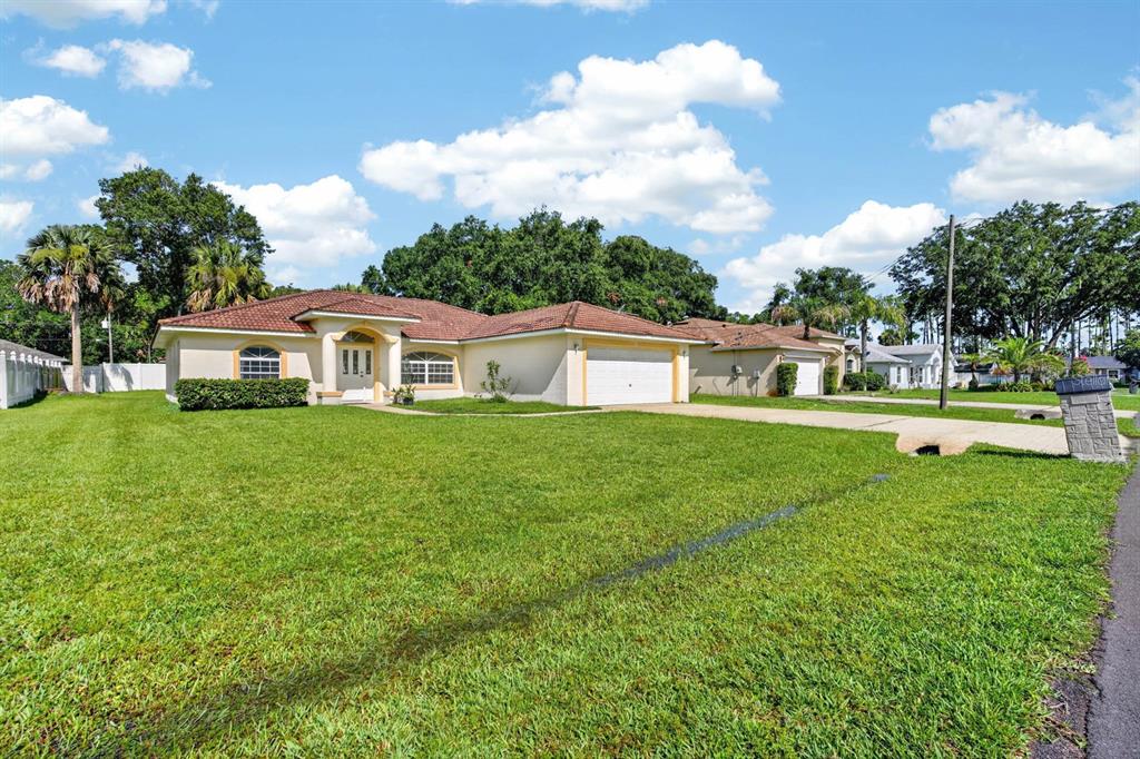 A single-story house with a tile roof, light-colored stucco exterior, and a two-car garage — 8 PILLORY LANE, PALM COAST, FL