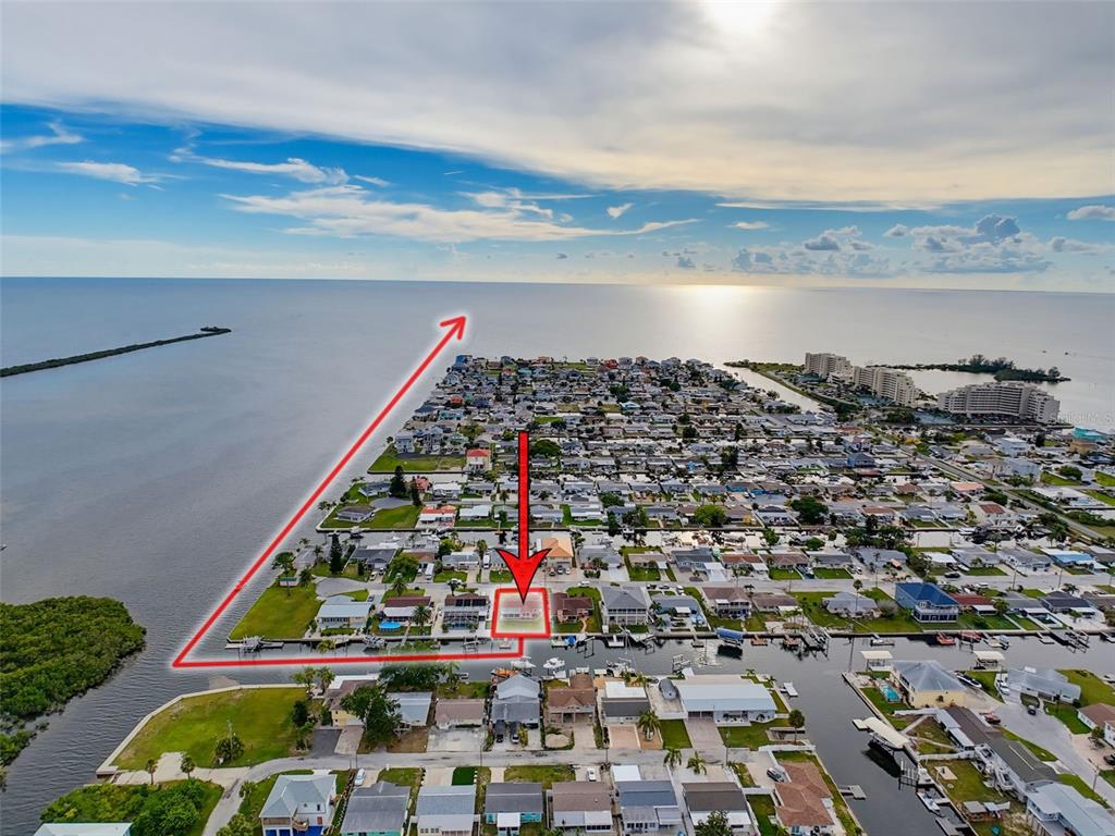 An aerial view shows a waterfront residential neighborhood with a red outline highlighting a property — 13530 MARIA DRIVE, HUDSON, FL