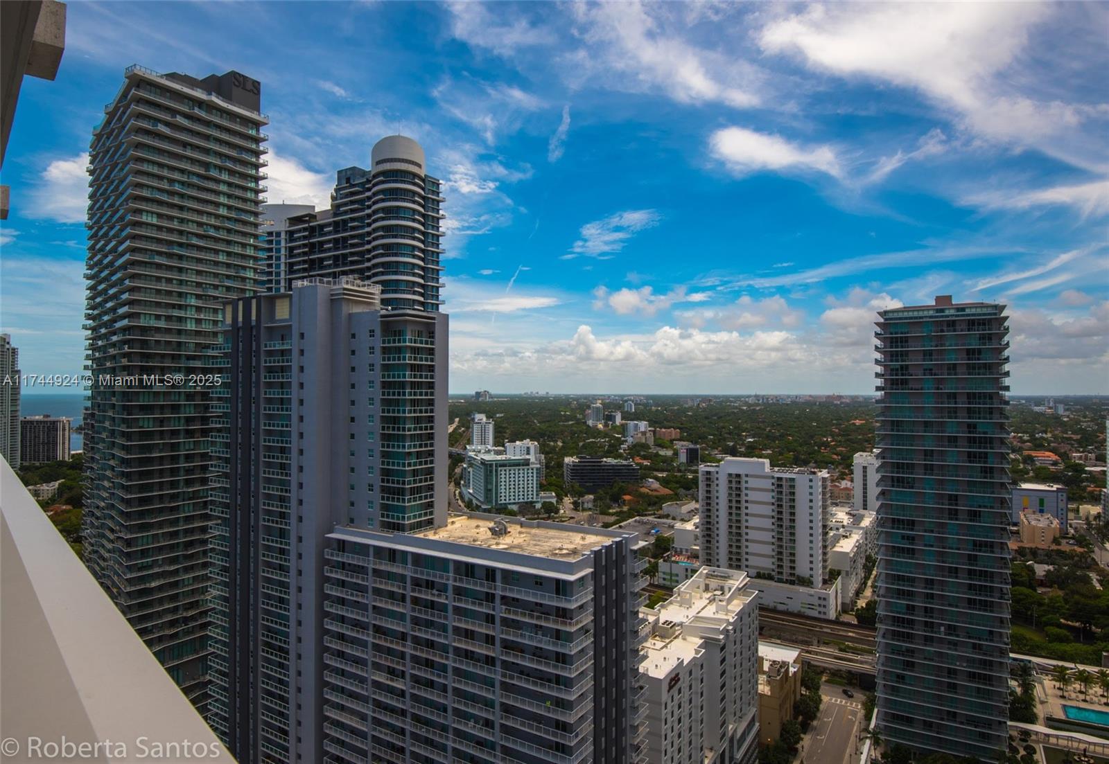 An elevated view of several modern high-rise apartment buildings in a dense urban city — 1080 Brickell Ave # 3205, Miami FL 33131, MIAMI, FL