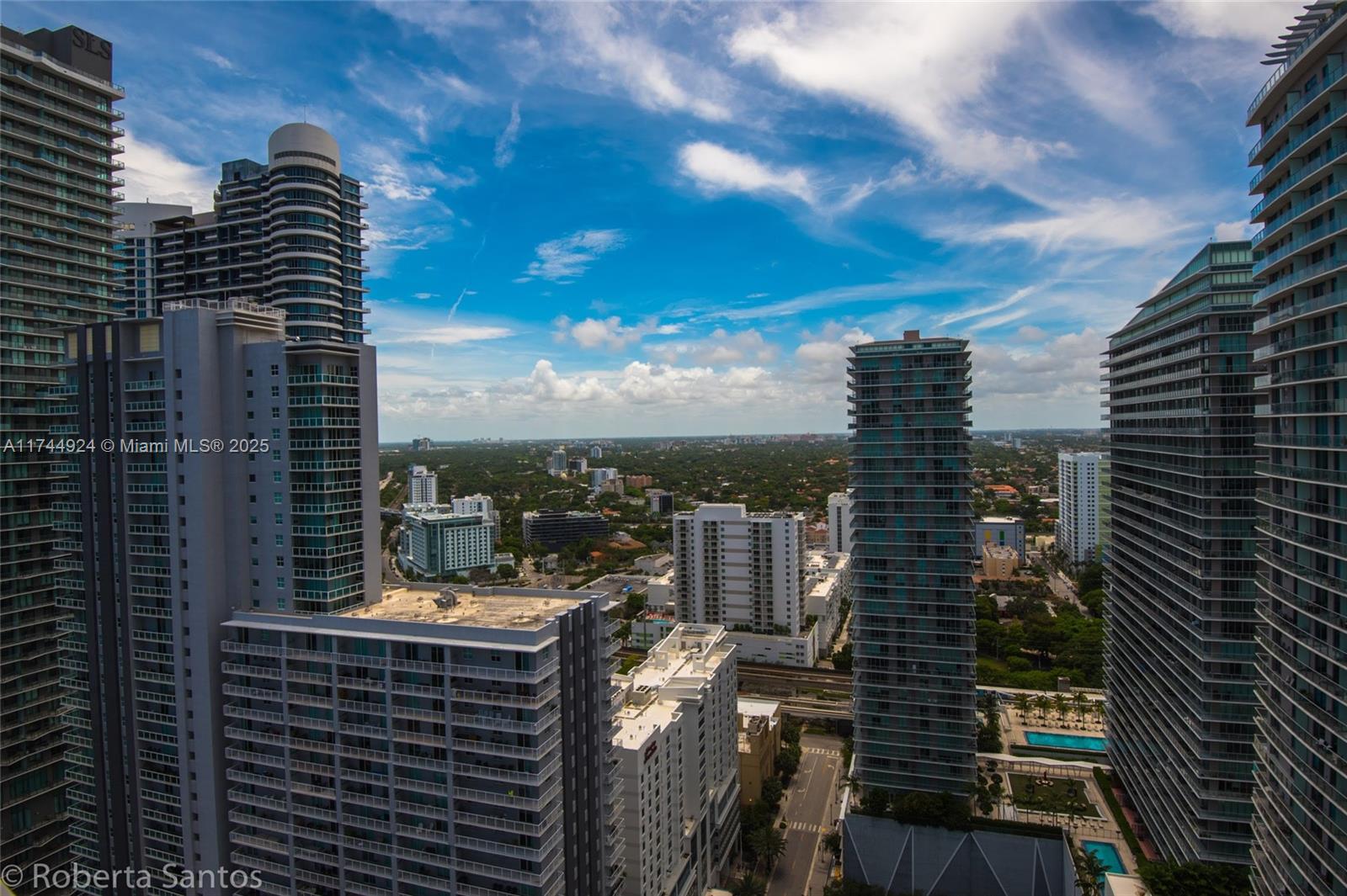 An elevated view of a dense urban skyline featuring multiple modern high-rise residential towers — 1080 Brickell Ave # 3205, Miami FL 33131, MIAMI, FL