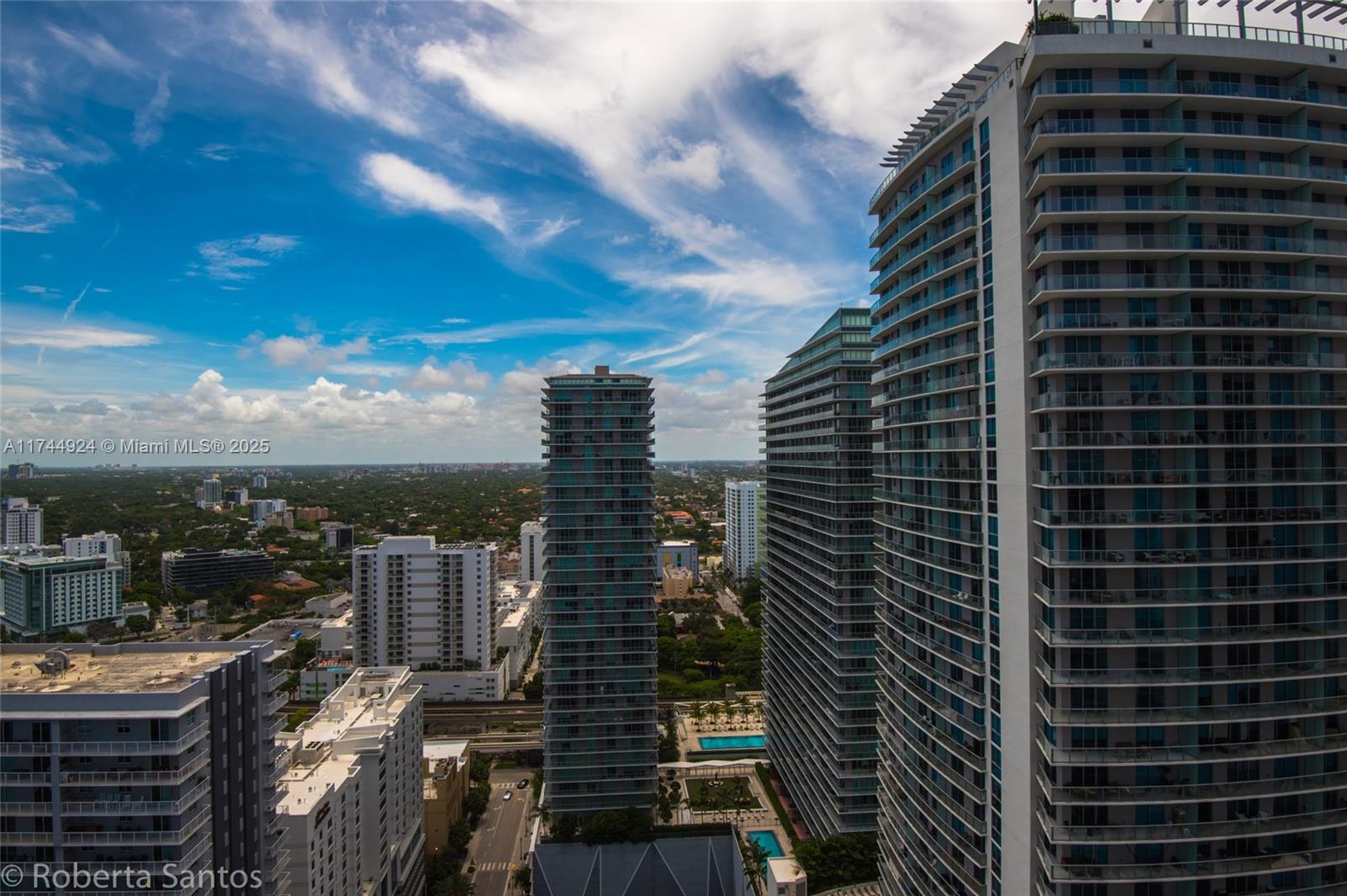 An elevated exterior view shows several modern high-rise residential towers in a dense urban setting — 1080 Brickell Ave # 3205, Miami FL 33131, MIAMI, FL