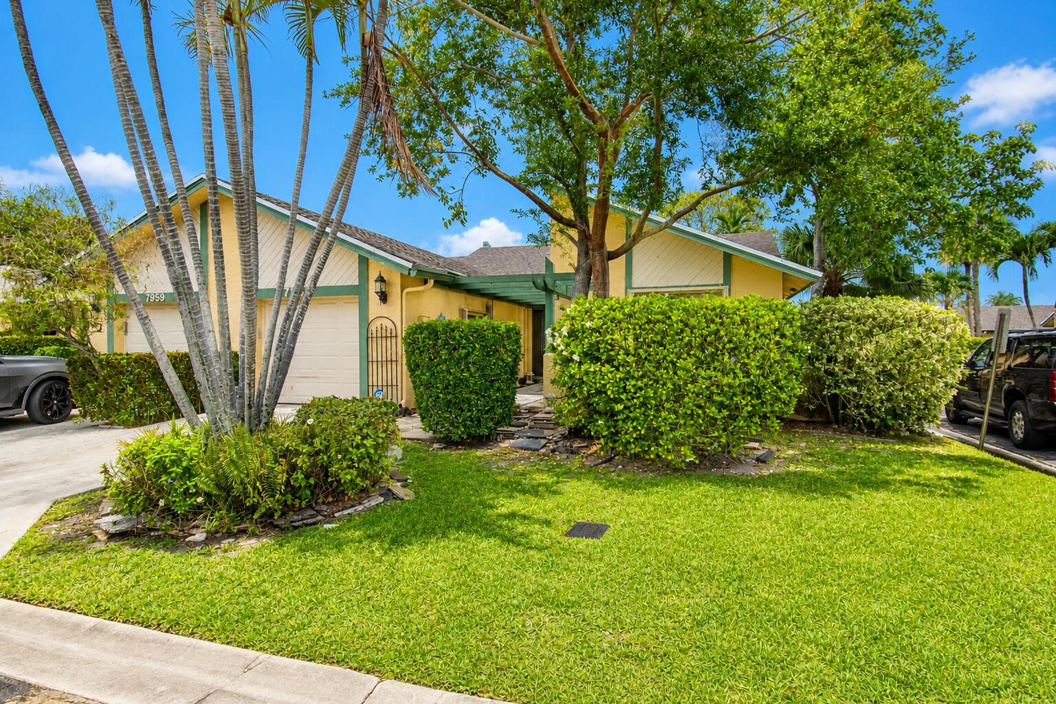 A yellow single-story house with a green-trimmed garage and a landscaped front yard — 7951 Little Lane, Boca Raton FL 33433, BOCA RATON, FL