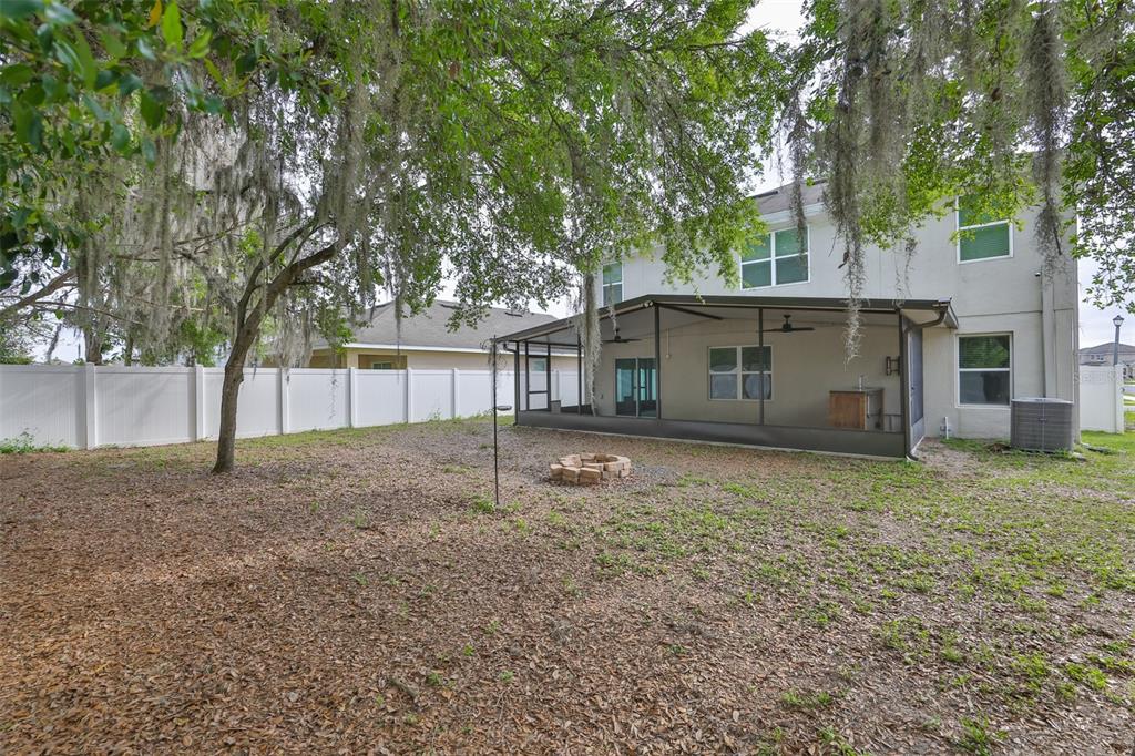 An aerial view of a community swimming pool with lounge chairs and a covered pavilion — 5461 MAGDALENE WAY, ZEPHYRHILLS, FL