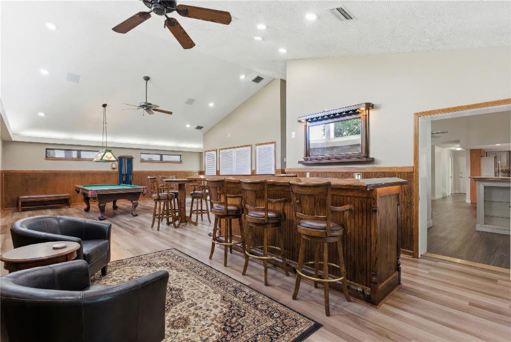 A game room features a pool table, a wooden bar with stools, and leather armchairs — 3612 SUGAR LOAF LANE, VALRICO, FL