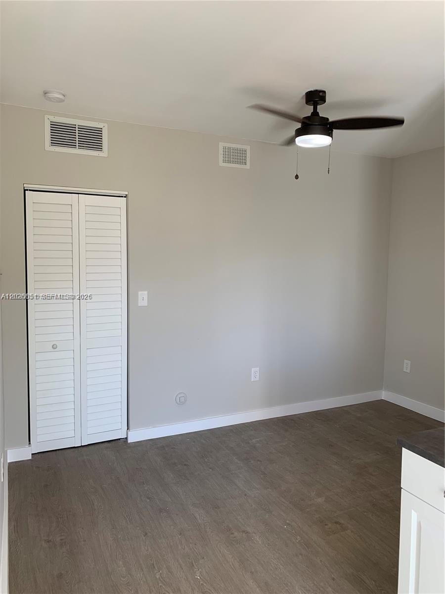 A room with light gray walls, wood-look flooring, a ceiling fan, and a white closet — 2932 NW 16th Ave # 2B, Miami FL 33142, MIAMI, FL