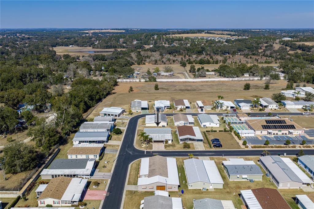 An aerial view shows a residential neighborhood with a single-story house marked by an arrow — 37519 COREY LEWIS AVENUE, ZEPHYRHILLS, FL
