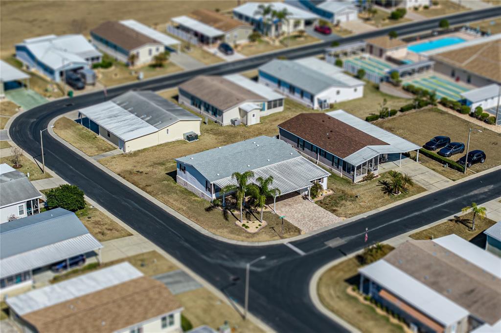 An aerial view shows a residential neighborhood with several single-story homes and paved streets — 37519 COREY LEWIS AVENUE, ZEPHYRHILLS, FL