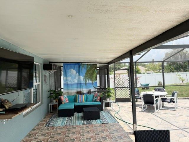 A screened-in pool area features a kidney-shaped pool, a raised spa, and paver decking — 4914 NEWTON COURT, ST CLOUD, FL