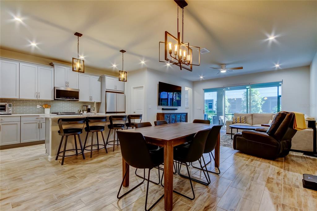 A kitchen features grey cabinets, stainless steel appliances, and a green subway tile backsplash — 19388 GREAT INTENTION WAY, LUTZ, FL