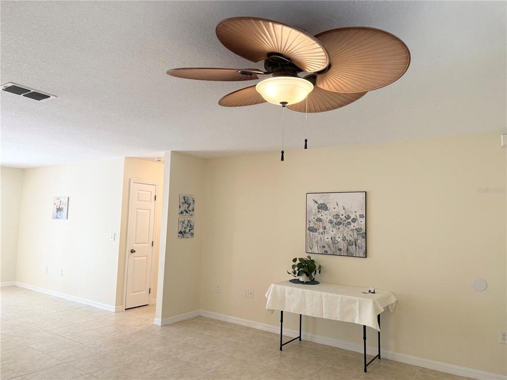 A room with tile flooring, a palm-leaf ceiling fan, and a table against the wall — 996 W COLBERT COURT, BEVERLY HILLS, FL
