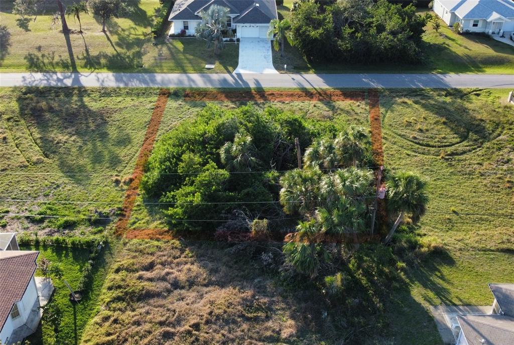 An aerial view shows a rectangular vacant lot marked with orange lines in a neighborhood — SAN REMO AVENUE, NORTH PORT, FL