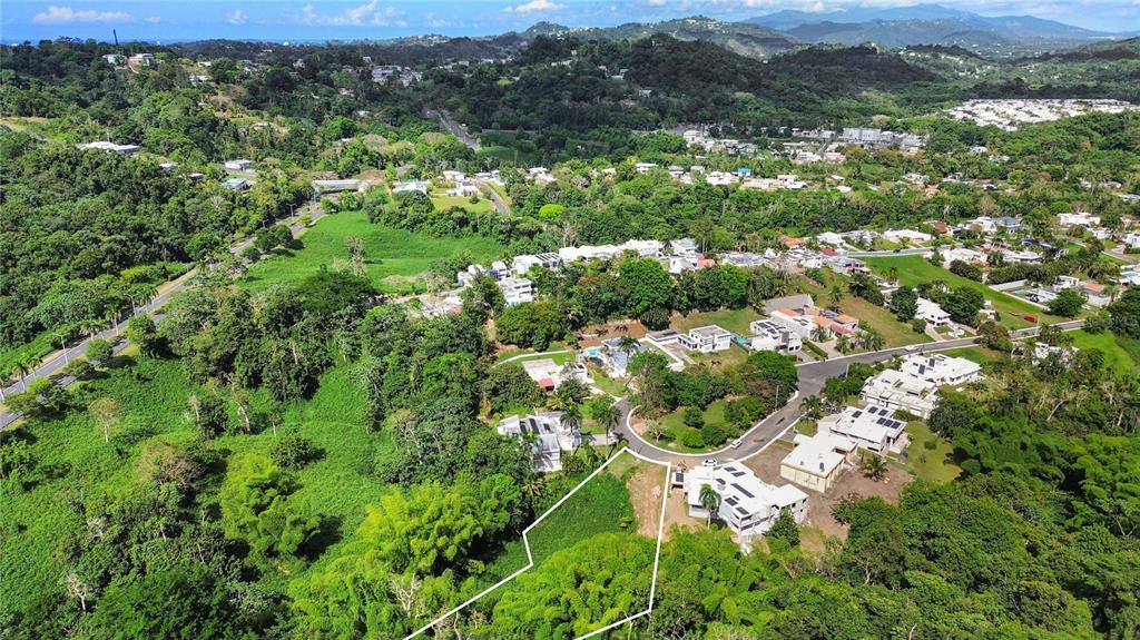 An aerial view shows a residential property lot outlined in white amidst lush green vegetation — 8 ESTRELLA BLQ G10, GUAYNABO, PR