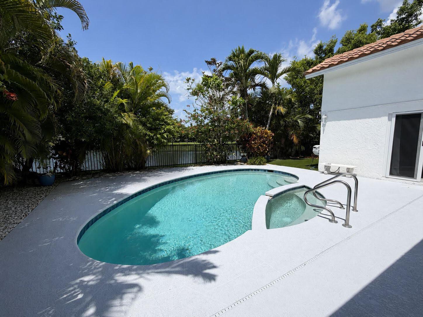 A brick house is surrounded by lush landscaping, palm trees, and a manicured lawn — 10562 Fenway Place, Boca Raton FL 33498, BOCA RATON, FL