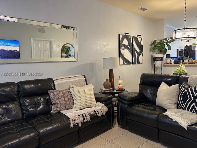 A living room features two black leather sofas, a large wall mirror, and abstract art — 160 SW 16th Ave, Homestead FL 33030, HOMESTEAD, FL