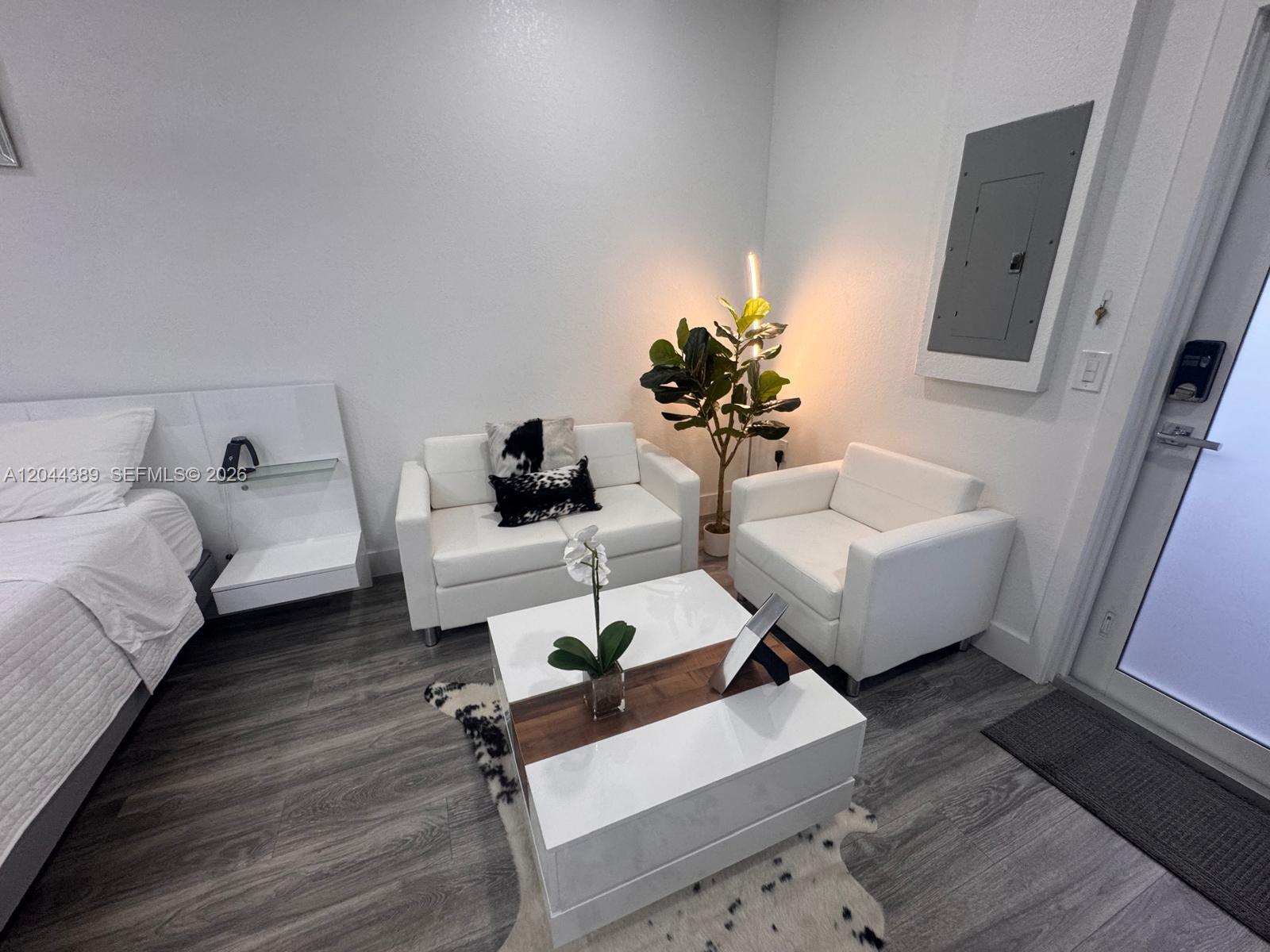 A small living area features white furniture, a coffee table, and a potted plant — 3265 SW 153rd Pl # 1, Miami FL 33185, MIAMI, FL