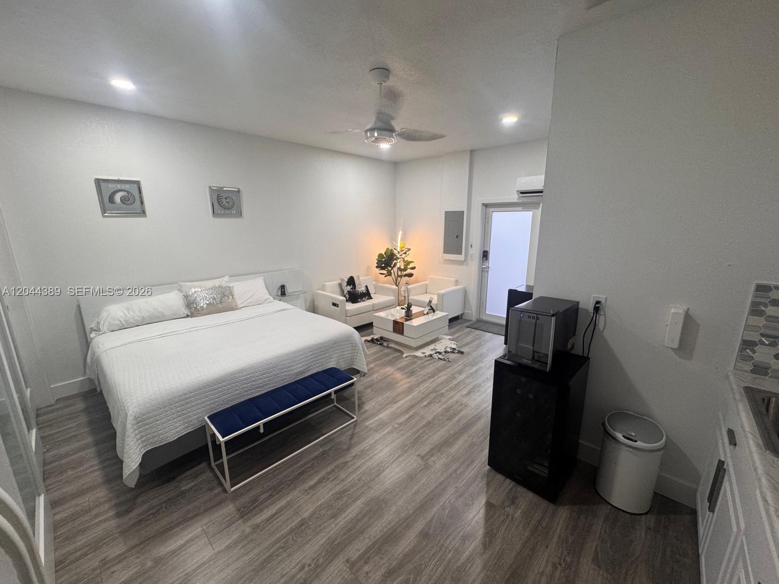 A studio apartment features a bed, a small seating area, and a kitchenette — 3265 SW 153rd Pl # 1, Miami FL 33185, MIAMI, FL